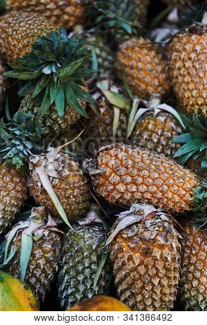 Big Pineapple, Close Up. Exotic Fruits At The Grocery Store. Different Varieties Of Pineapples On A 