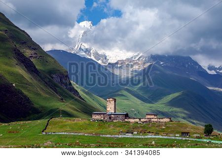 View Of The Ushguli Village At The Foot Of Mt. Shkhara. Lamaria Monastery, Old Rock Tower. Travel.