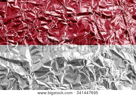 Indonesia Flag Depicted In Paint Colors On Shiny Crumpled Aluminium Foil Closeup. Textured Banner On