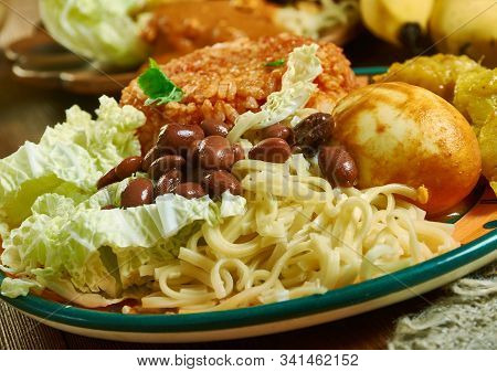 Waakye, Ghanaian Cuisine, Cooked Rice And Beans,  Mixed With  Boiled Eggs, Stewed Meat. Traditional 