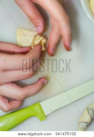The Hands Of A Girl Prepares The Dough For Cookies
