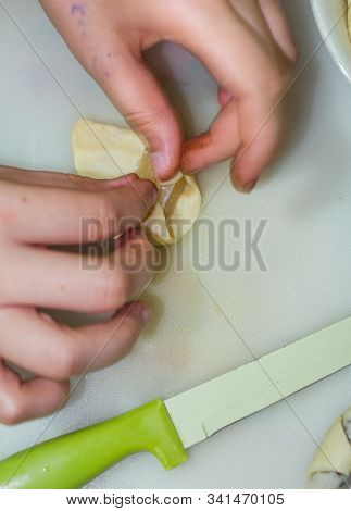 The Hands Of A Girl Prepares The Dough For Cookies