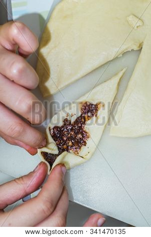 The Hands Of A Girl Prepares The Dough For Cookies