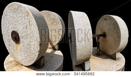 Two Old Millstones For The Production Of Olive Oil Isolated On Black Background, Italy