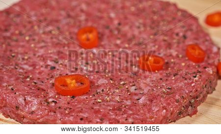 Cook Makes Meat Medallions For Burgers. Chef In Black Food Gloves Makes Cutlet. Cutlets Are Leveled 