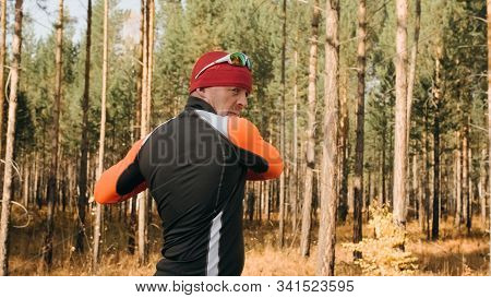 Training An Athlete On The Roller Skaters. Biathlon Ride On The Roller Skis With Ski Poles, In The H