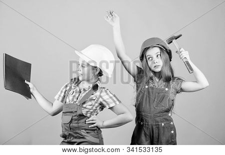 Little Kids In Helmet With Tablet And Hammer. Small Girls Repairing Together In Workshop. Happy Chil
