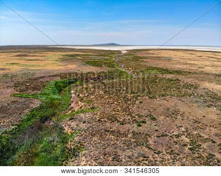 Small Red Water River Leading To Baskunchak Saline Lake In Nature Reserve
