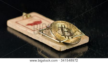 Bitcoin Coin Falling On A Mouse Trap. Naive Investment Concept And Losing Money