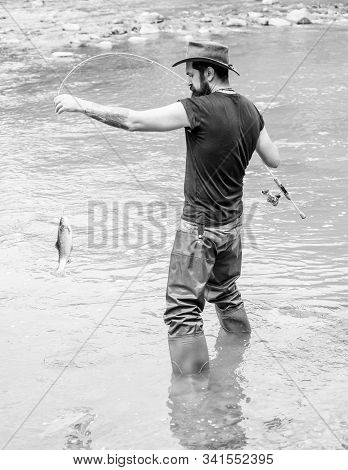 Fisherman With Fishing Rod. Mature Man Fly Fishing. Man Catching Fish. Bearded Fisher In Water. Summ