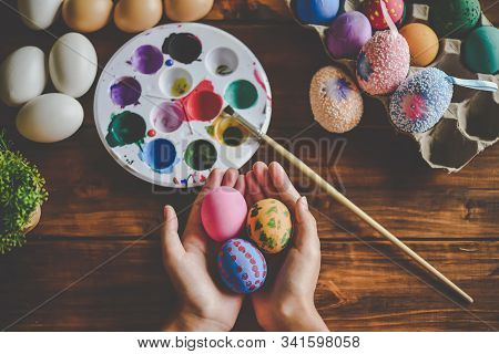 Young Girl Painting Easter Eggs For Eastertime At Home