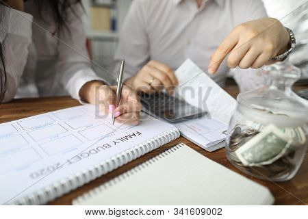 Close-up View Of Couple Calculating Family Budget For New Year. Spouse Accounting Expenses And Plann