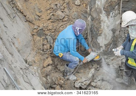 Two Workers Are Helping To Cut The Steel Wire By Gas In The Concrete Pile.