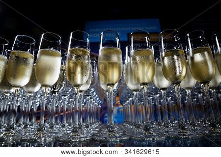 Many Champagne Glasses Stand On A Glass Table