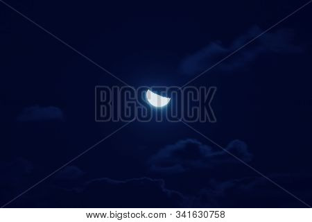 Half Of Bright Moon Among Dark Clouds In Night Sky With Motion Blur. Moon Gathering Concept