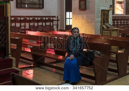 Jerusalem, Israel, December 28, 2018 : Believer Sits On A Bench And Rests After Prayer In St. Nichol
