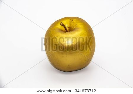 A Golden Apple On A White Background