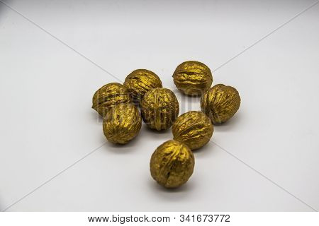 A Golden Walnuts On A White Background