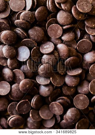 Dark Couverture Chocolate Callets Background. Modern Food Concept.
