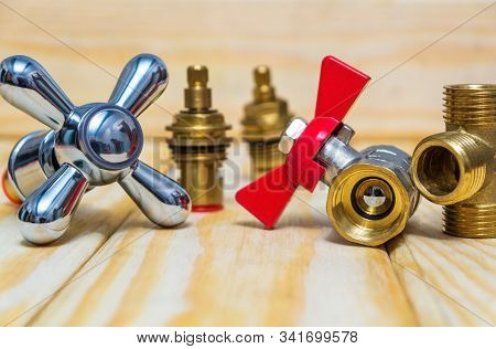 Cruciform Hot And Cold Water Main Switch Of Spare Parts On Wooden Boards