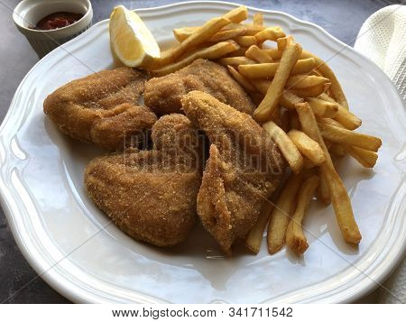 Breaded Crispy Chicken With French Fries And Sauce.
