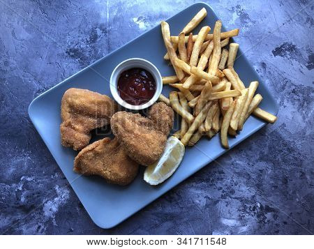 Breaded Crispy Chicken With French Fries And Sauce.