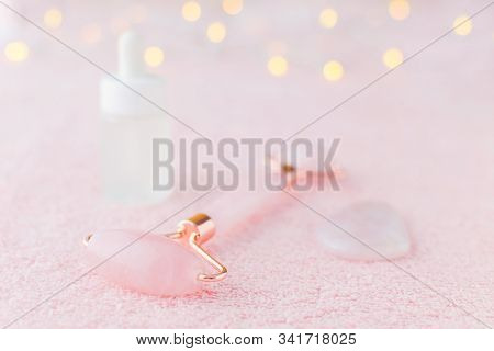 Real Rose Quartz Facial Roller, Gua Sha Massage Stone And Face Serum Bottle, Selective Focus