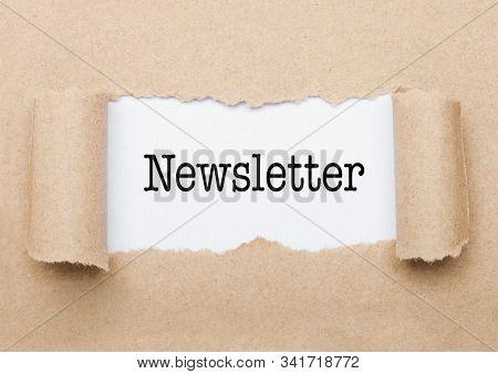 Newsletter Concept Text Appearing Behind Torn Brown Paper Envelope