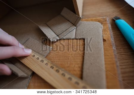 Hand Holding Ruller, Making Of Diy Project Out Of Cardboard Waste