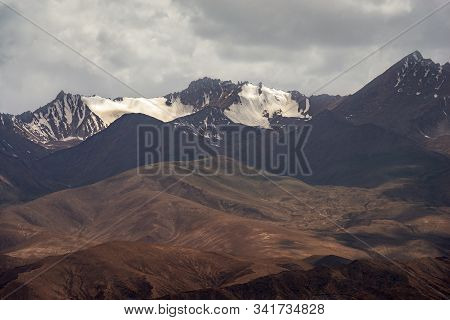 Great View Of Snow Capped Brown Black Mountain Ranges And Cloudscape Of Kunlun Mountains In Pamirs P