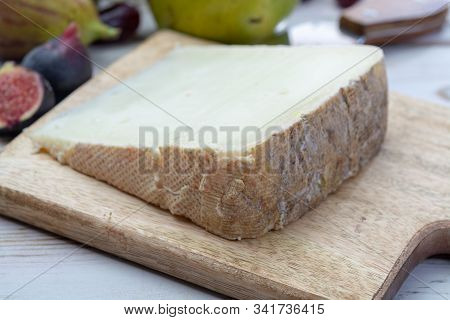 Piece Of French Cheese Tomme De Brebis Made From Sheep Milk Served As Dessert With Fresh Figs And Pe