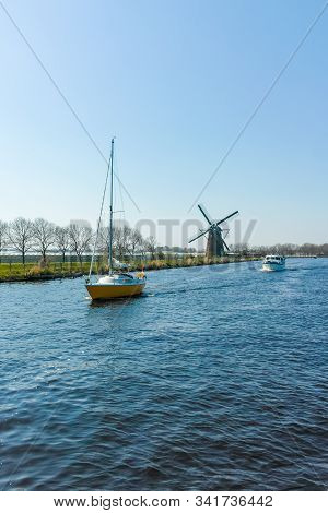 Waterways Of North Holland With Boats And View On Traditional Dutch Mill, Spring Landscape