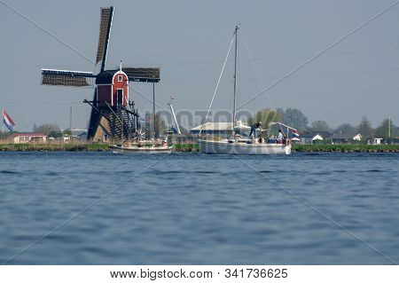 Waterways Of North Holland And View On Traditional Dutch Wind Mill, Spring Landscape