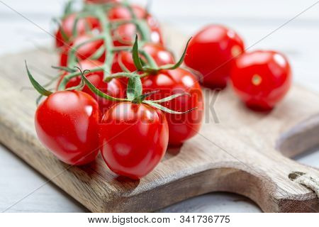 Vine Of Fresh Ripe Red Cherry Prunella Tomates