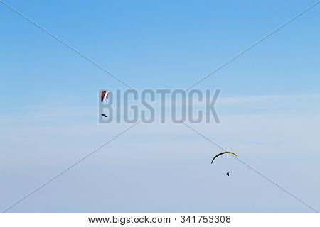 Paraglider On Blue Sky. Borso Del Grappa, Famous Paragliding Site, Italy