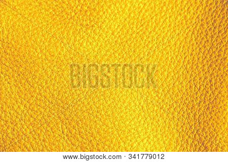 Texture Of Genuine Leather. Yellow Background. Golden Shade Material.