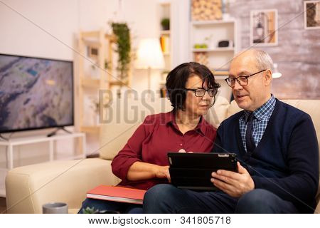 Beautiful Old Couple Using A Digital Tablet To Chat With Their Family