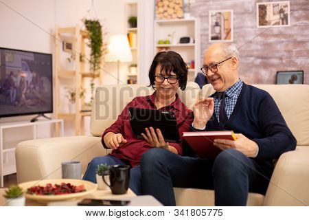 Beautiful Old Couple Using A Digital Tablet To Chat With Their Family