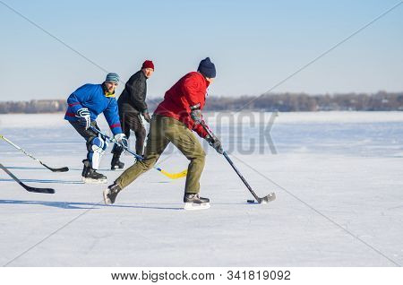 Dnipro, Ukraine - January 22, 2017: Group Of Different Ages Ordinary People Playing Hockey On A Dnip