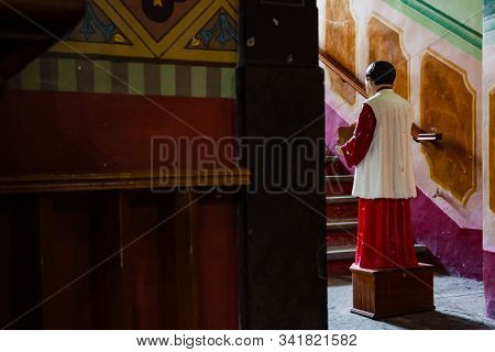 altar boy collecting money with donation box for catholic church. conceptual image