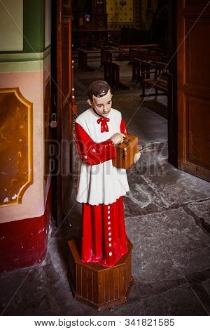 altar boy collecting money with donation box for catholic church. conceptual image