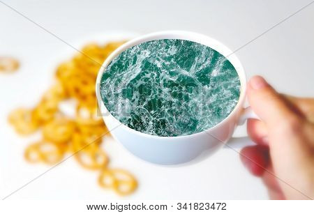 White Cup With Water. Sea. Ocean. Sea Waves. Creative Postcard. Sea In The Hand.