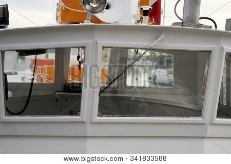 Detail Of White Ferry Cockpit In A Harbour