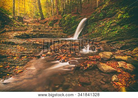 Autumn Mountain Waterfall Stream In The Rocks With Colorful Red Fallen Dry Leaves, Natural Seasonal 
