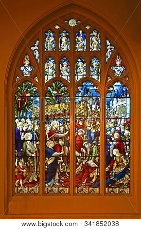 St Neots, Cambridgeshire, England - December 07, 2018: Stain Glass Window Depicting  The Triumphant 