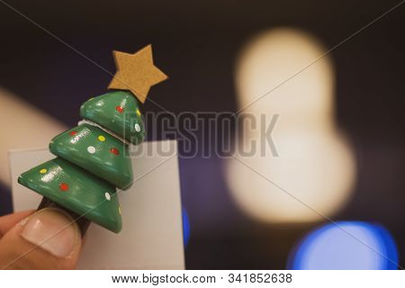 Man Holding Miniature Christmas Tree For Holiday Decoration