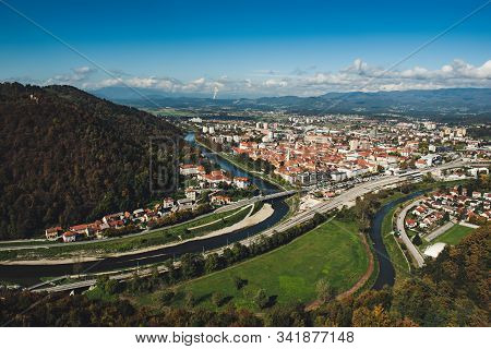 Aerial View To The City Celje In Slovenia. Autumn Trees, Green Meadows And Red Roofs. Outdoor Travel