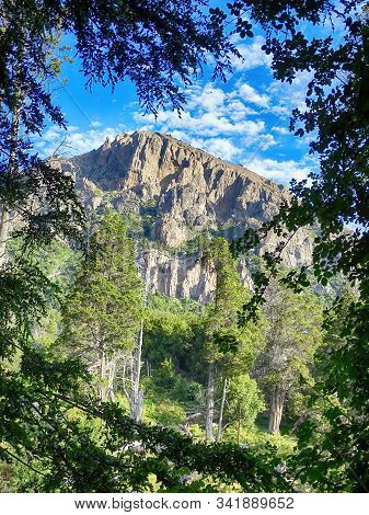 Great Mountain Seen From The Forest, There Is A Lot Of Vegetation Around, Blue Sky With Clouds. Cerr