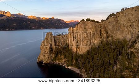 Lake Traful In Patagonia, Argentina. There Is A Rocky Mountain And Many Pine Trees Sorrounding The L