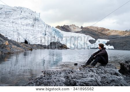 Tourist Man Looking At The Pastoruri Glacier In One Of The Highest Points Of Cordillera Blanca In Pe